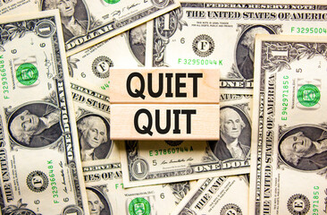 Quiet quit symbol. Concept words Quiet quit on wooden blocks. Beautiful background from dollar...