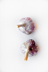 Two garlic bulbs on a white background. Beautiful garlic close-up.