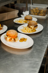 Close-up - burger with french fries on revolving table in a restaurant, a working restaurant in blur against background