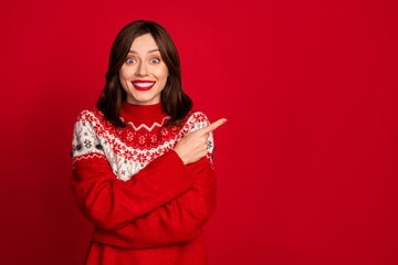 Photo of excited impressed astonished girl straight hairstyle dressed red sweater indicating empty space isolated on red color background