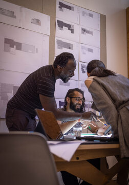 Architects planning with digital tablet in conference room meeting
