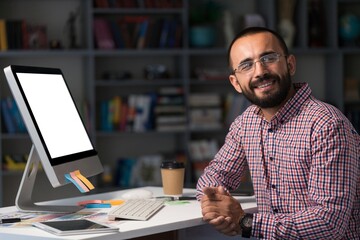Fototapeta premium Bearded businessman working on laptop in office. Video online webinar.