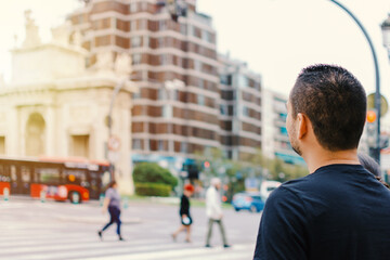 Close-up of the head of a man from behind looking at a monument in a European city