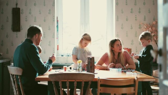 Young family spending time together at the kitchen table
