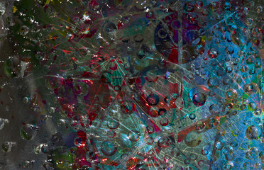 Spheres of various diameters are located against a multicolored background with geometric figures silhouettes. Abstract fantasy. 3D render.