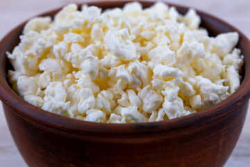 Fresh delicious cottage cheese in a bowl close-up