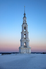 Sunrise at the old bell tower of St. Nicholas Cathedral on the Uglich reservoir. Kalyazin. Tver region, Russia