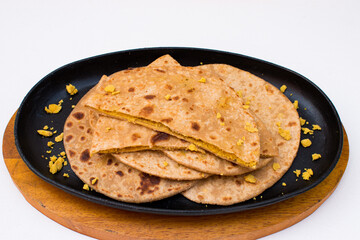 Dal paratha or chana dal stuffed paratha in black plate in white background.