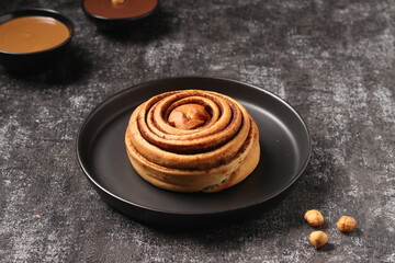 Delicious Cinnabon painted on a dark black background