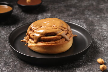 Delicious Cinnabon painted on a dark black background