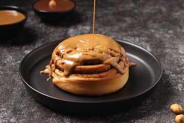 Delicious Cinnabon painted on a dark black background