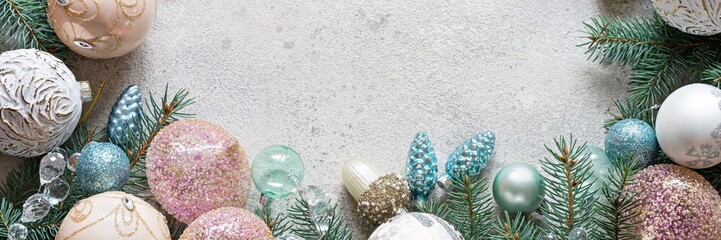 Christmas decorations (toys) in pastel colors for the Christmas tree and garlands on a gray...