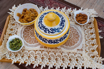 Indian sweet with ingredient. Healthy and home made dessert made with milk and jaggery. container closed.