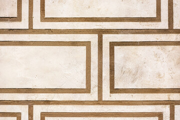 Fragment of a beige wall with a pattern in the form of brown stripes for use as an abstract background and texture.