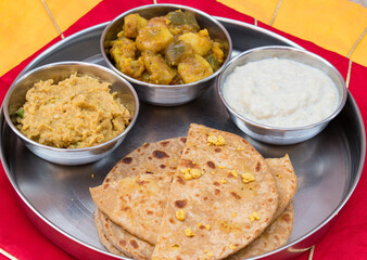 Dal Puri or dal stuffed paratha in plate and Gur kheer, Payasam, Phirni or rice pudding, mixed veg called dalna sabzi and oal chutney. Bihari thali .