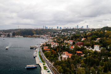 Fototapeta premium Tanker, cargo ship passes through the Bosporus. Awesome view of the Bosphorus Bridge (the 15 July Martyrs Bridge) connecting Europe to Asia.