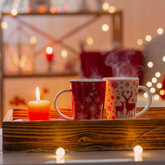 cup of hot drink with christmas decorations in white and red colors at home