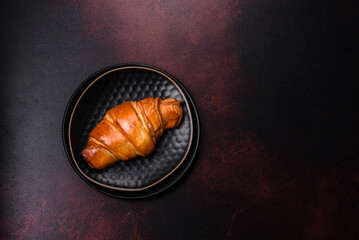Beautiful different Christmas decorations and croissant on a brown concrete table