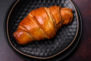 Beautiful different Christmas decorations and croissant on a brown concrete table
