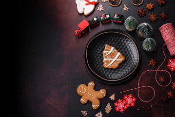 Beautiful different Christmas decorations and gingerbread on a brown concrete table