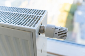 Heating radiator with adjustment knob installed on the middle position in a residential apartment