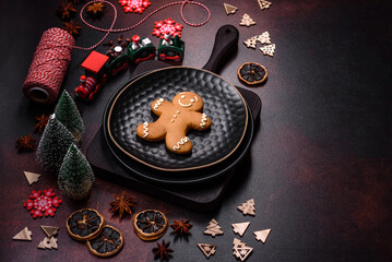 Beautiful different Christmas decorations and gingerbread on a brown concrete table