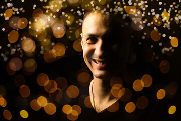 Back silhouette of man isolated on magical background for Halloween with garlands, bokeh lights, hanging glowing pumpkins, smoke. Mystical night forest with jack o lantern. Copy space