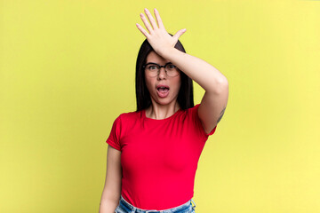 young adult pretty woman raising palm to forehead thinking oops, after making a stupid mistake or...