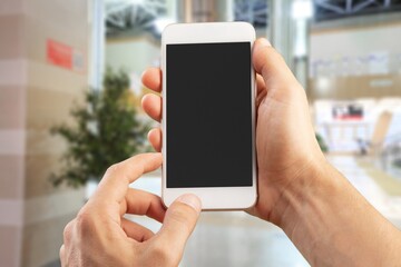 Customer hands using phone with a blank screen