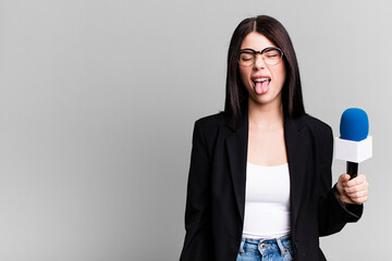 with cheerful and rebellious attitude, joking and sticking tongue out. journalist or presenter with...