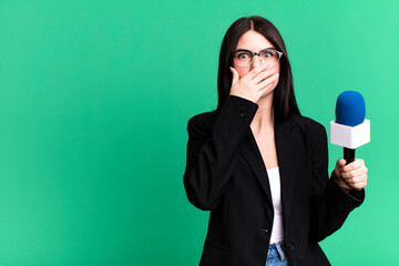 covering mouth with hands with a shocked. journalist or presenter with a micro