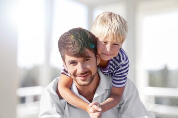 Happy young father with child, playing together