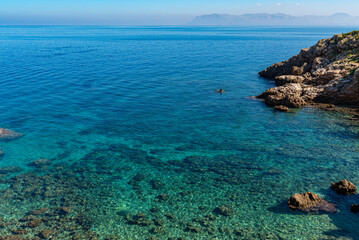 The Disa cove in the nature reserve of the Zingaro National Park in Sicily. The small bay with the pebble beach, offers the possibility to swim in the crystal-clear water of the Mediterranean Sea