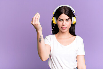 making capice or money gesture, telling you to pay. listening music qith a headphones