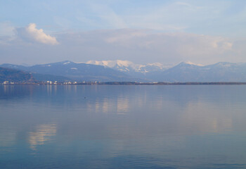 tranquil wintery lake Constance (Bodensee) with the snowy Alps in the background (Lindau in Germany)	
