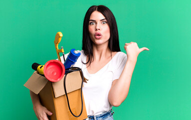 looking astonished in disbelief. housekeeper with a toolbox