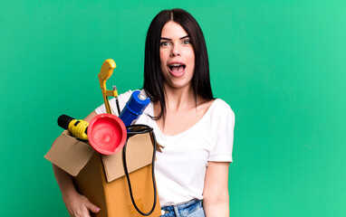looking happy and pleasantly surprised. housekeeper with a toolbox
