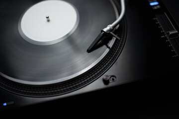 Listen to music with hi fi turntable player and vinyl record. DJ turn table plays analog disc with...