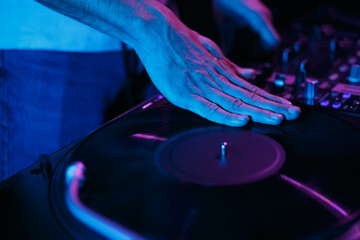 Hip hop disc jockey scratches vinyl record on turn table player. Club dj scratching records on...