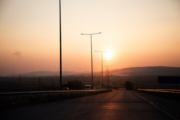 car in road .beautiful sunset