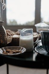 Aesthetic breakfast. Milk coffee, milk tea, sugar, almond, almond cakes, biscuits, marzipans and puffs. British breakfast in a cozy home. Autumn mood.
