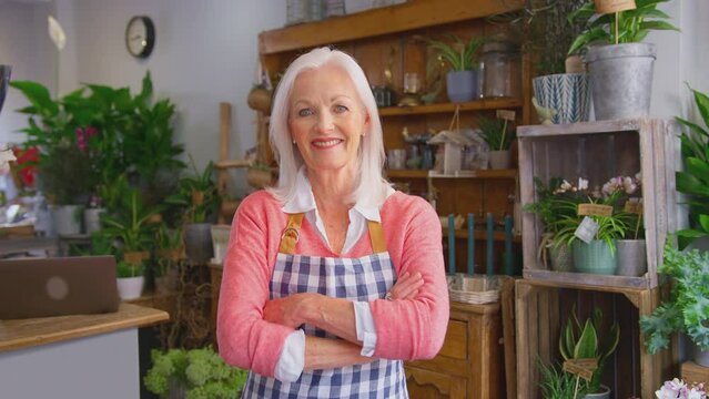 Portrait of smiling mature female owner of florists shop - shot in slow motion