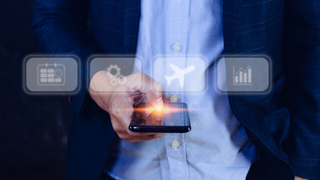 Businessman touching smartphone to select flight by pressing touch screen airplane button,Business Airplane transportation concept - Powered by Adobe