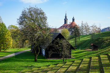 Idyllic farmland scenery in slovenia. Small wooden barn in front of the Castle Skofja near small historic town skofja loka.