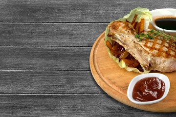 Tasty hot meat steak on wooden board