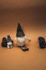 Cute dwarf, in a high hat and a snowman on a brown background. Фон или postcard Merry Christmas greetings