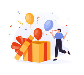 Woman opening gift box and looking at festive confetti thrown out of it. Concept of birthday present, holiday greetings