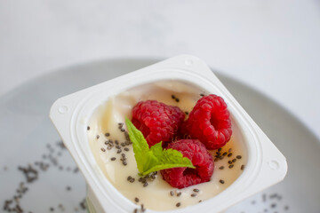 Yogurt chia seeds, raspberries, mint on a light background