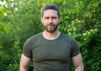 unshaven guy in shirt. caucasian guy with beard. mature guy outdoor