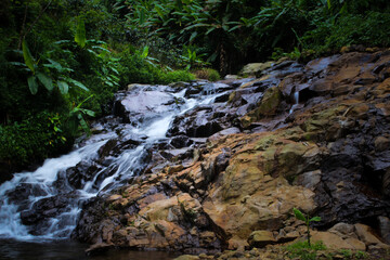 beautiful waterfall in a small river in the middle of the forest